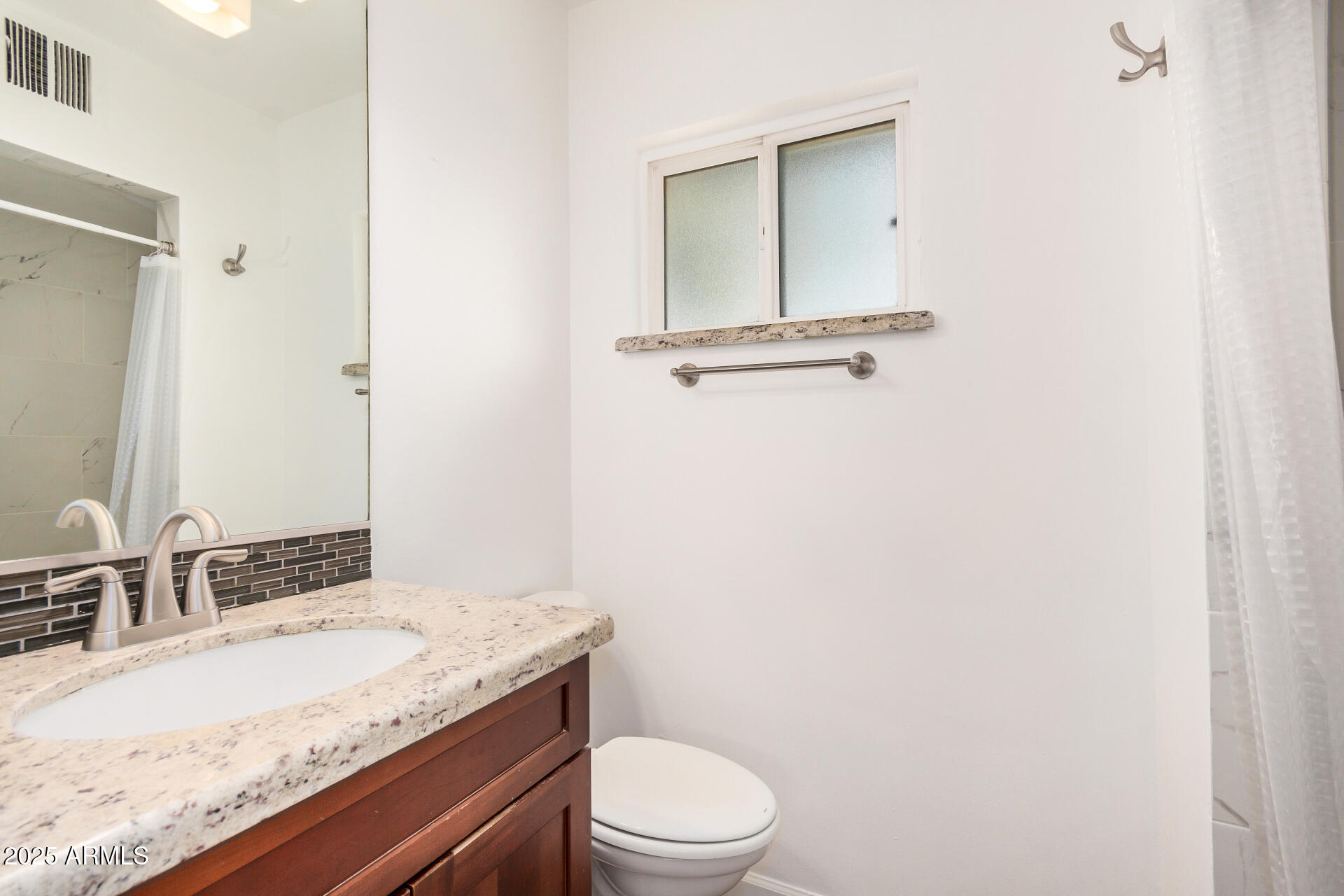 8912 North 17th Avenue Phoenix, AZ 85021 - Photo 19 of 33 a bathroom with a granite countertop sink a toilet and mirror