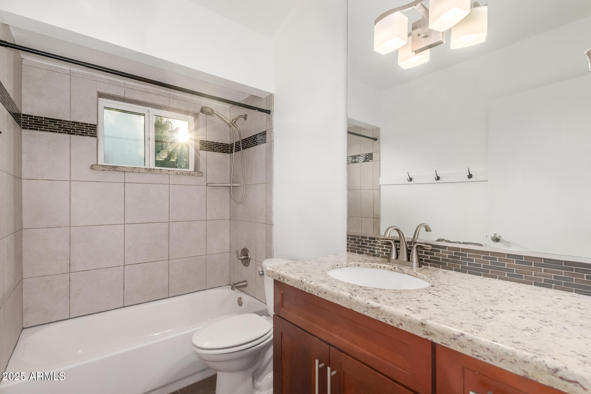 8912 North 17th Avenue Phoenix, AZ 85021 - Photo 24 of 33 a bathroom with a granite countertop sink a toilet a mirror and bathtub