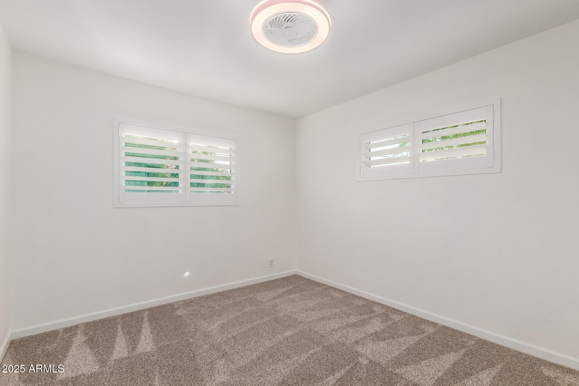 8912 North 17th Avenue Phoenix, AZ 85021 - Photo 25 of 33 an empty room with windows and a fan