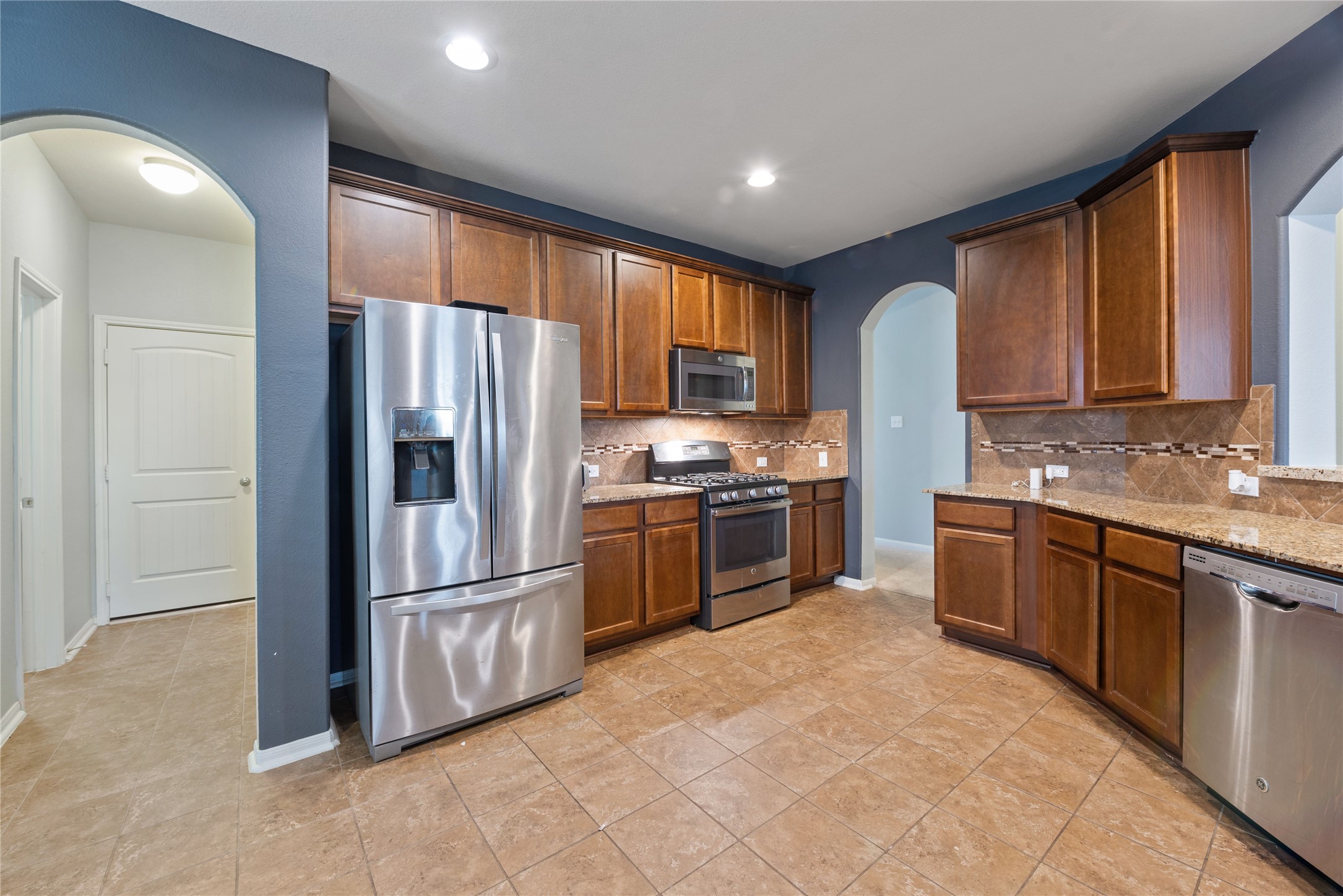 970 Jennifer Street Alvin, TX 77511 - Photo 8 of 27 a kitchen with granite countertop a refrigerator stove top oven a sink and dishwasher