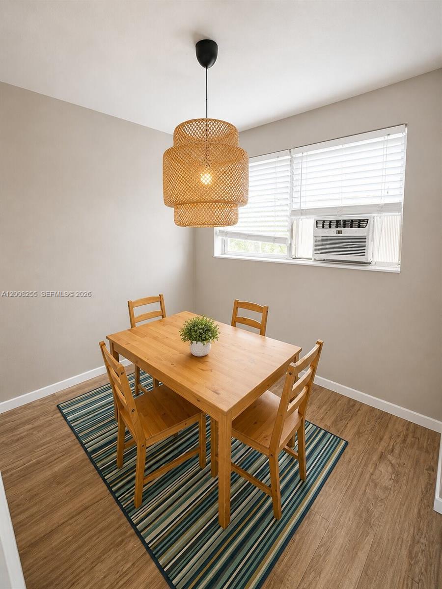 375 Southwest 19th Avenue, Unit 4 Miami, FL 33135 - Photo 15 of 30 a view of a dining room with furniture and wooden floor