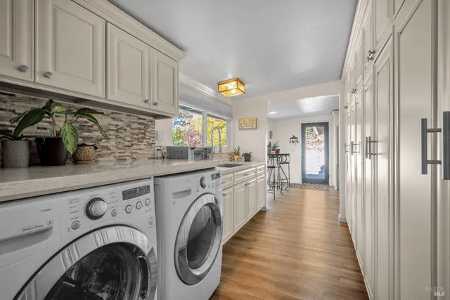 a view of a hallway with washer and dryer
