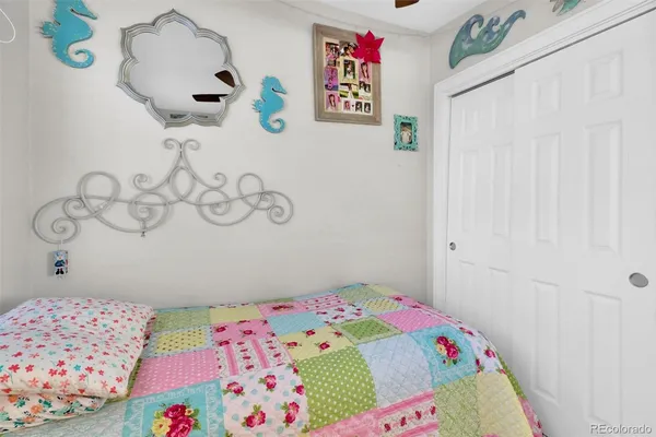 a bedroom with a bed and a dresser in it