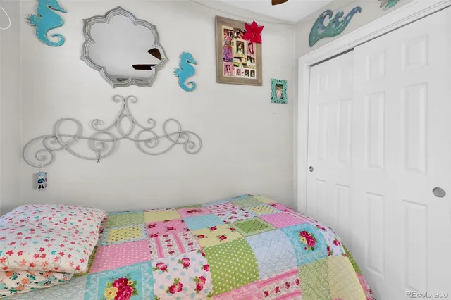 a bedroom with a bed and a dresser in it