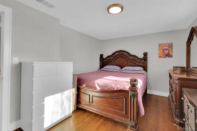 a bedroom with a bed and a desk