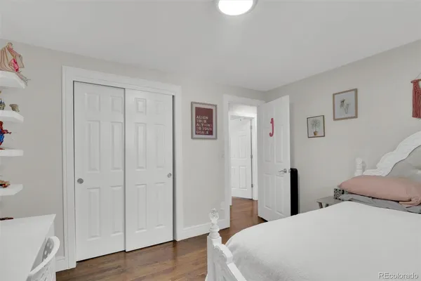 a bedroom with a bed and a mirror