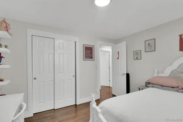 a bedroom with a bed and a mirror