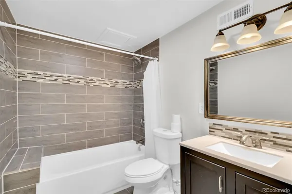 a bathroom with a sink mirror toilet and bathtub