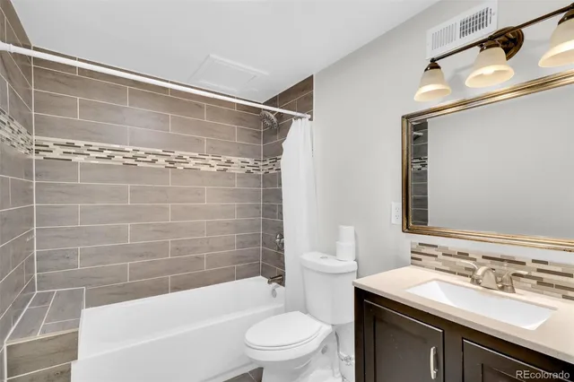 a bathroom with a sink mirror toilet and bathtub