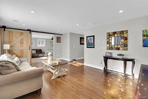 a living room with furniture and a wooden floor