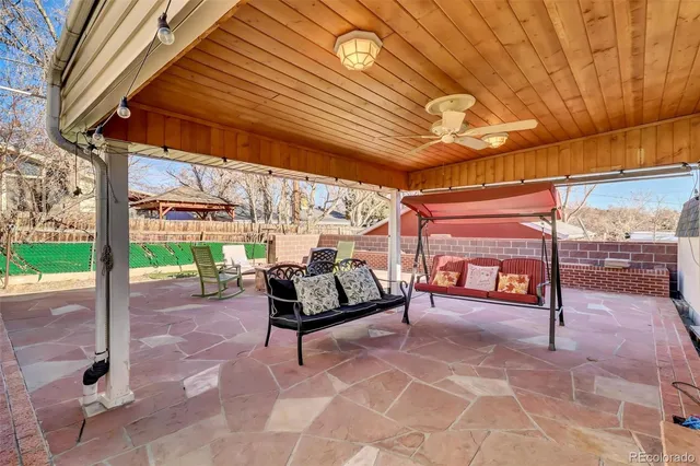 a view of a patio with a table and chairs under an umbrella