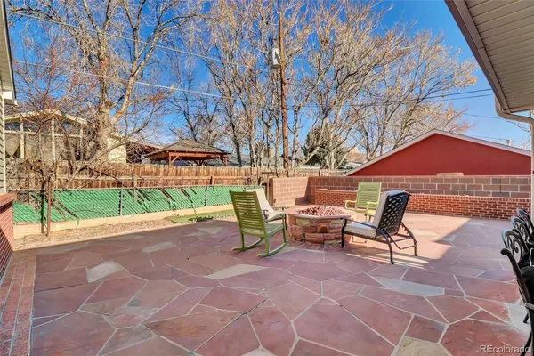 a backyard view of a house with a patio