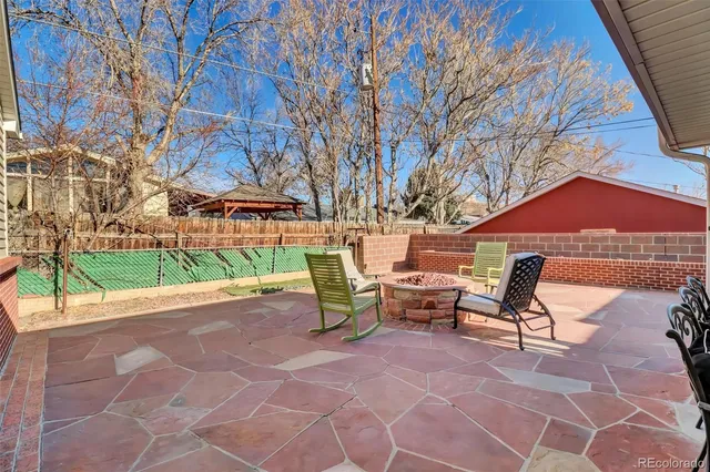 a backyard view of a house with a patio