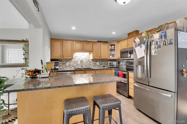 a kitchen with refrigerator and cabinets