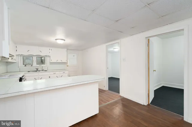 a kitchen with granite countertop white cabinets white stainless steel appliances with a sink and dishwasher