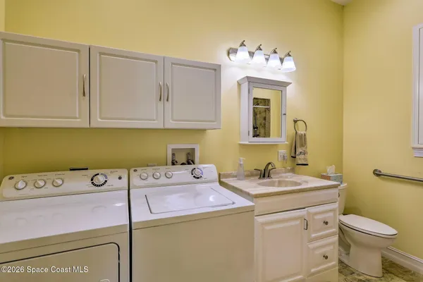 a bathroom with a sink vanity and toilet