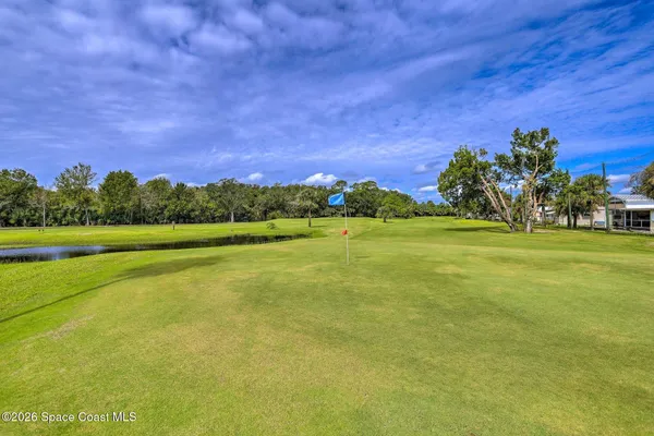 a view of a golf course with a building