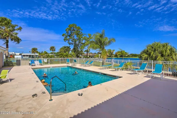 a view of a swimming pool with a lounge chairs