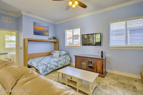 a bedroom with two beds and a chandelier