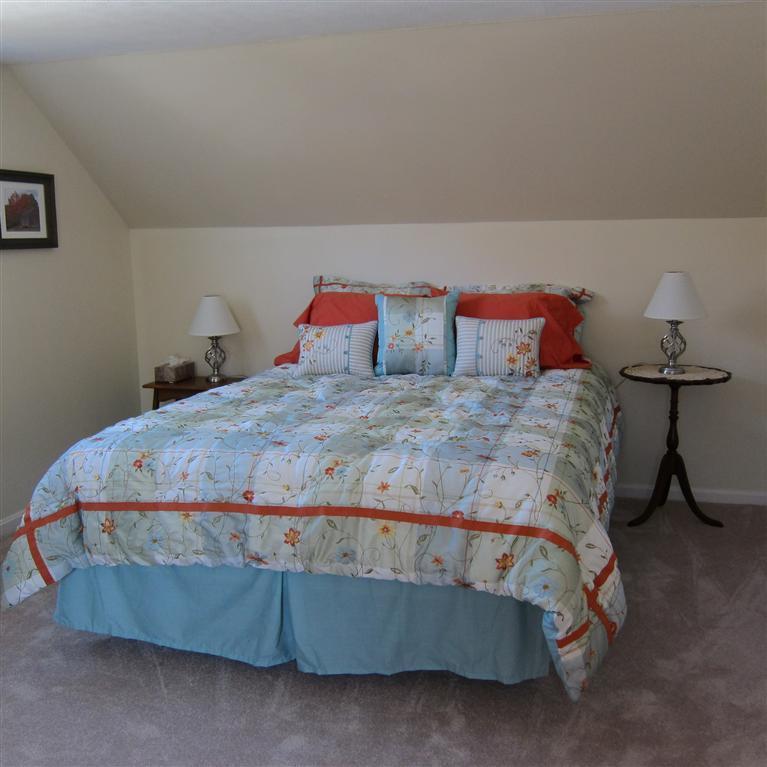 7 Oak Ridge Road East Falmouth, MA 02536 - Photo 7 of 13 a bedroom with a bed and a stool