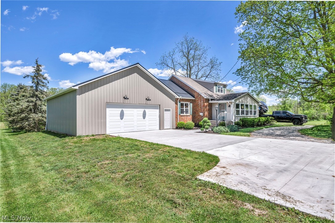 7983 Wadsworth Road Medina, OH 44256 - Photo 2 of 42 View of front facade featuring a front yard and a garage