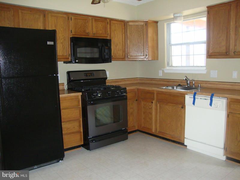 202 Choptank Road Stafford, VA 22556 - Photo 6 of 13 a kitchen with a stove and a microwave