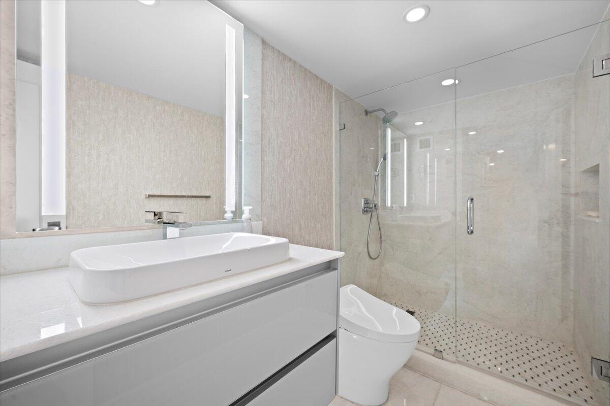 2000 South Ocean Boulevard, Unit 11D Boca Raton, FL 33432 - Photo 11 of 31 a bathroom with a sink a toilet and shower
