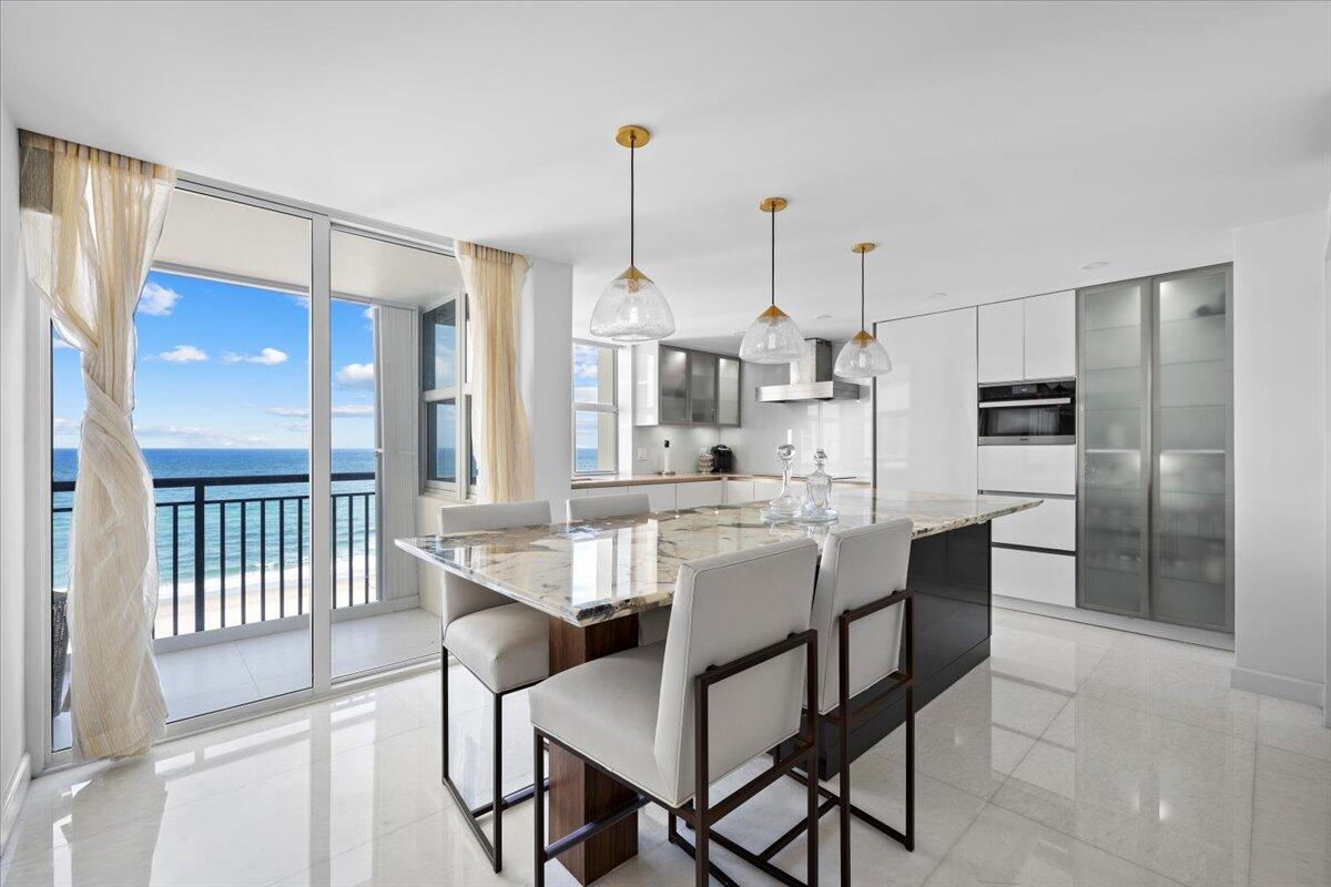 2000 South Ocean Boulevard, Unit 11D Boca Raton, FL 33432 - Photo 5 of 31 a view of a dining room and chairs in a kitchen