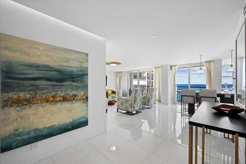 a view of living room filled with furniture and a floor to ceiling window