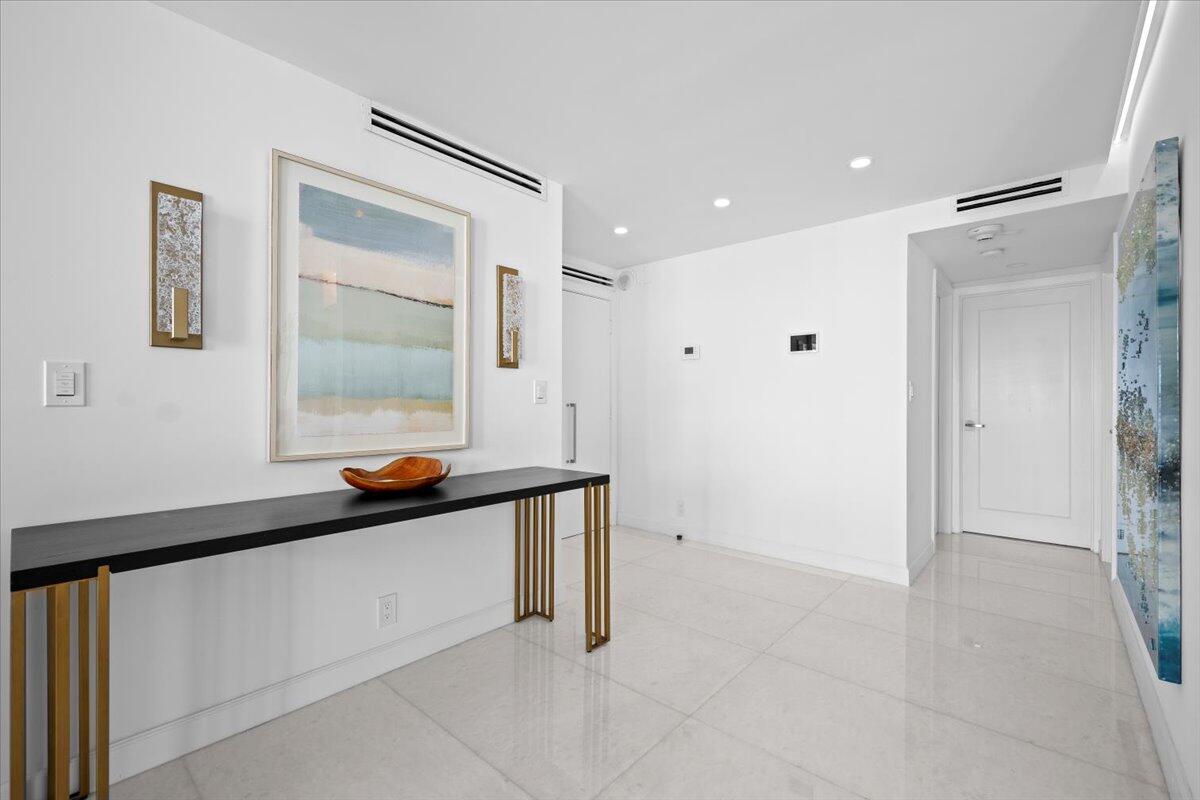 2000 South Ocean Boulevard, Unit 11D Boca Raton, FL 33432 - Photo 8 of 31 a room with a bed and a mirror