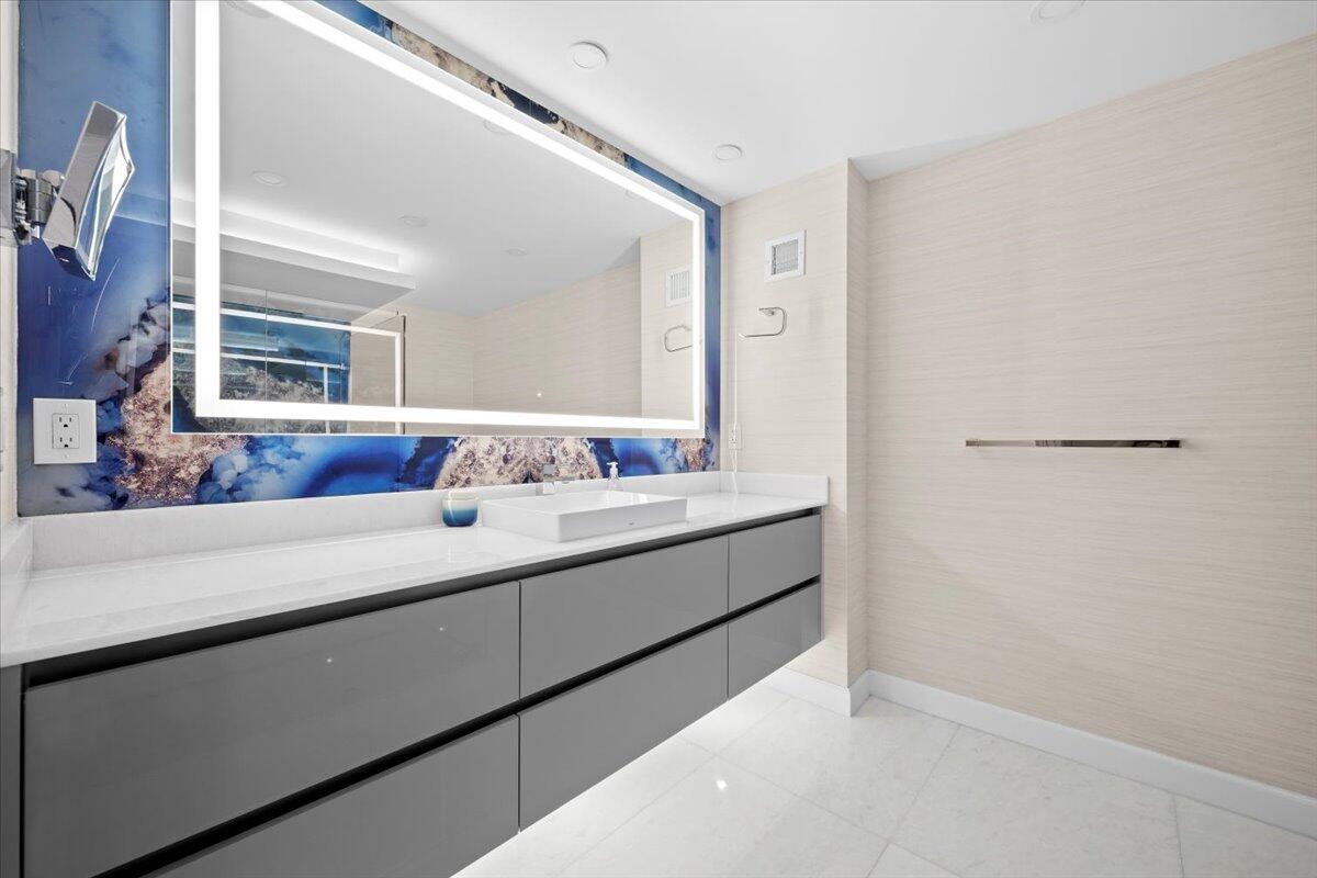 2000 South Ocean Boulevard, Unit 11D Boca Raton, FL 33432 - Photo 9 of 31 a bathroom with a sink and a mirror