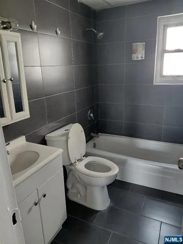 a bathroom with a toilet sink and shower