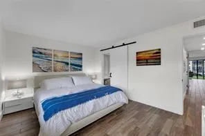 a bedroom with a bed and a night stand