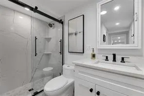a bathroom with a sink toilet and shower