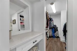 a view of walk in closet with clothes and shoes
