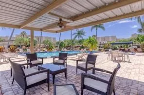 a view of a swimming pool with a patio and a yard