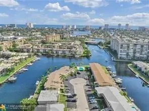 an aerial view of residential houses with outdoor space and lake view
