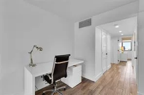 a view of a room with wooden floor and bathroom