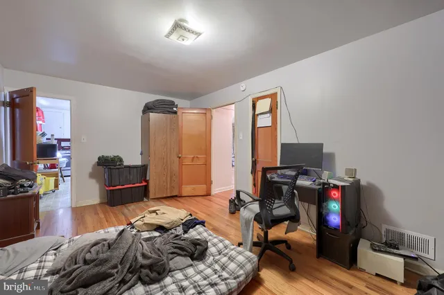 a bedroom with furniture and a flat screen tv