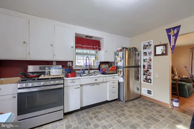 a kitchen with stainless steel appliances granite countertop a stove and a refrigerator