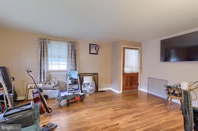 a view of a livingroom with furniture and a flat screen tv