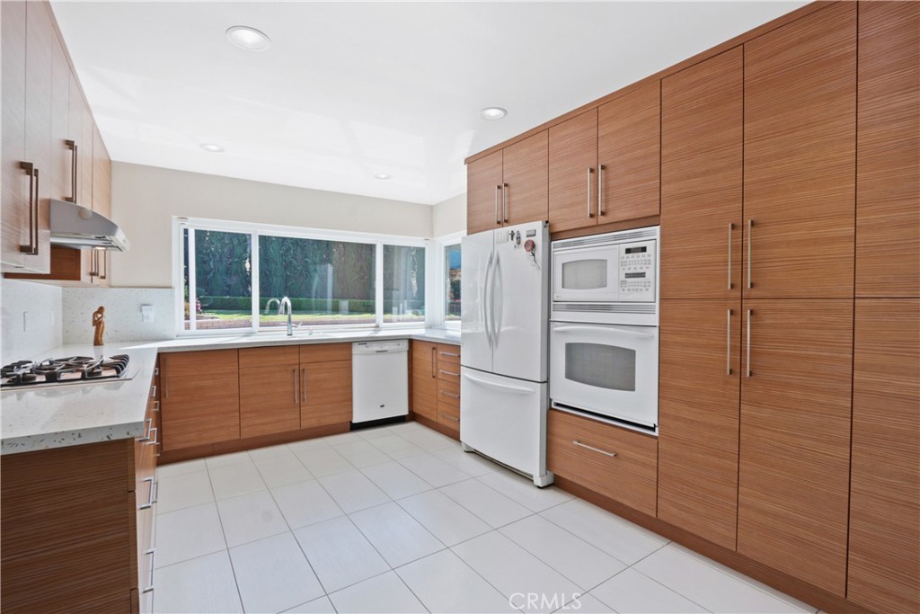 6046 Altmark Avenue Whittier, CA 90601 - Photo 13 of 27 a kitchen with stainless steel appliances a refrigerator sink and stove