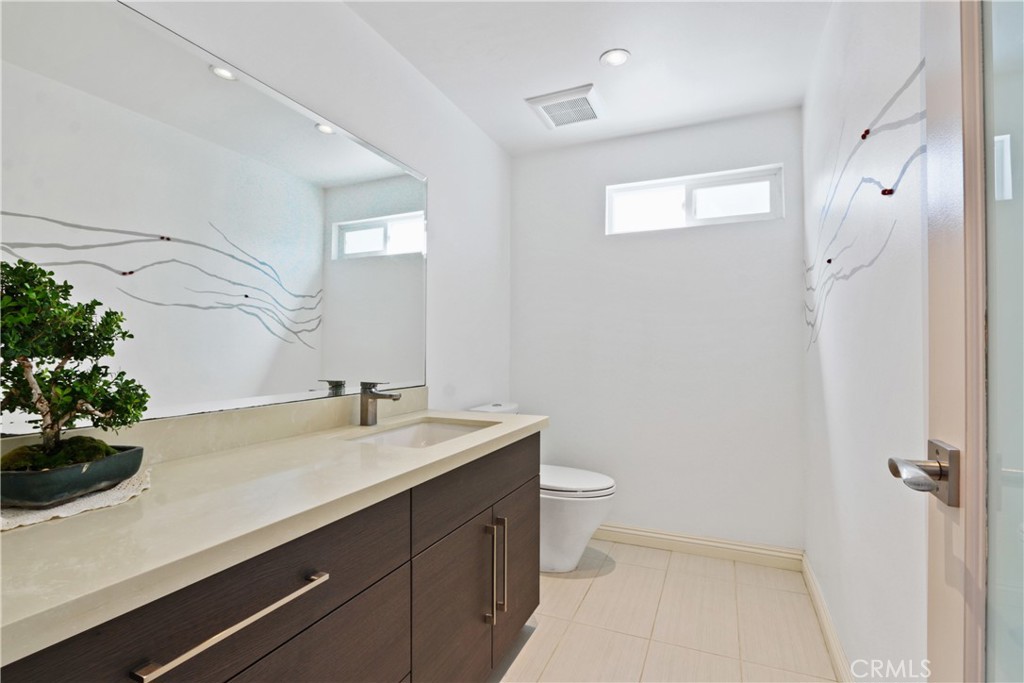 6046 Altmark Avenue Whittier, CA 90601 - Photo 16 of 27 a bathroom with a sink a toilet and shower