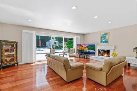 a dining room with furniture entryway and wooden floor