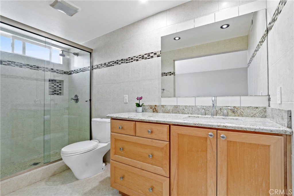 6046 Altmark Avenue Whittier, CA 90601 - Photo 20 of 27 a bathroom with a granite countertop sink toilet and shower