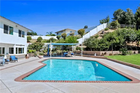 a view of a swimming pool with a patio