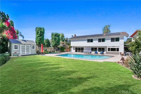 a view of a backyard with sitting area