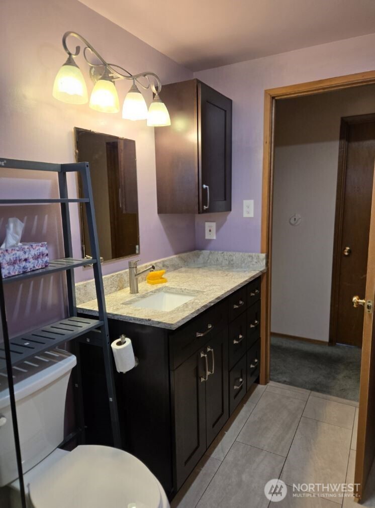 4316 Northeast 10th Street Renton, WA 98059 - Photo 11 of 25 a bathroom with a sink vanity and toilet