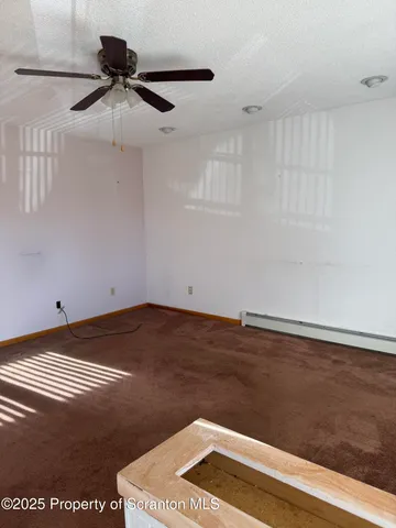 a view of a ceiling fan and wooden floor