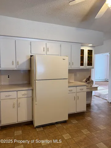 a kitchen with sink refrigerator and cabinets